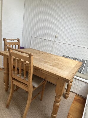 Enjoy meals in this cozy dining area with a traditional table and four chairs.