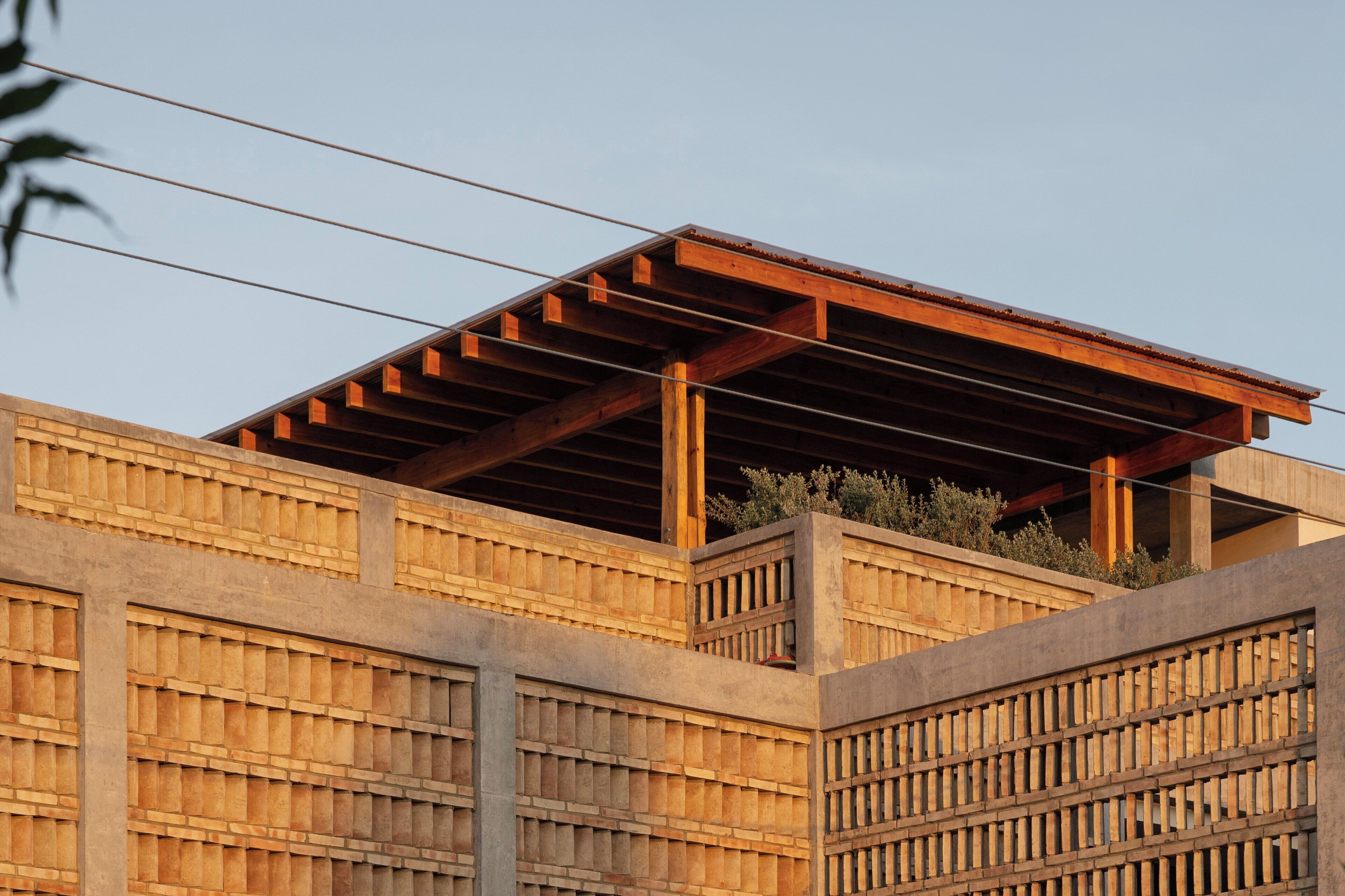 A modern building with a wooden facade and a flat roof structure.
