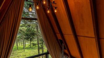 A cozy cabin with a wooden deck, a hot tub, and a fireplace.