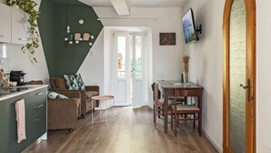A compact living space with a kitchenette, a dining area, and a seating area.