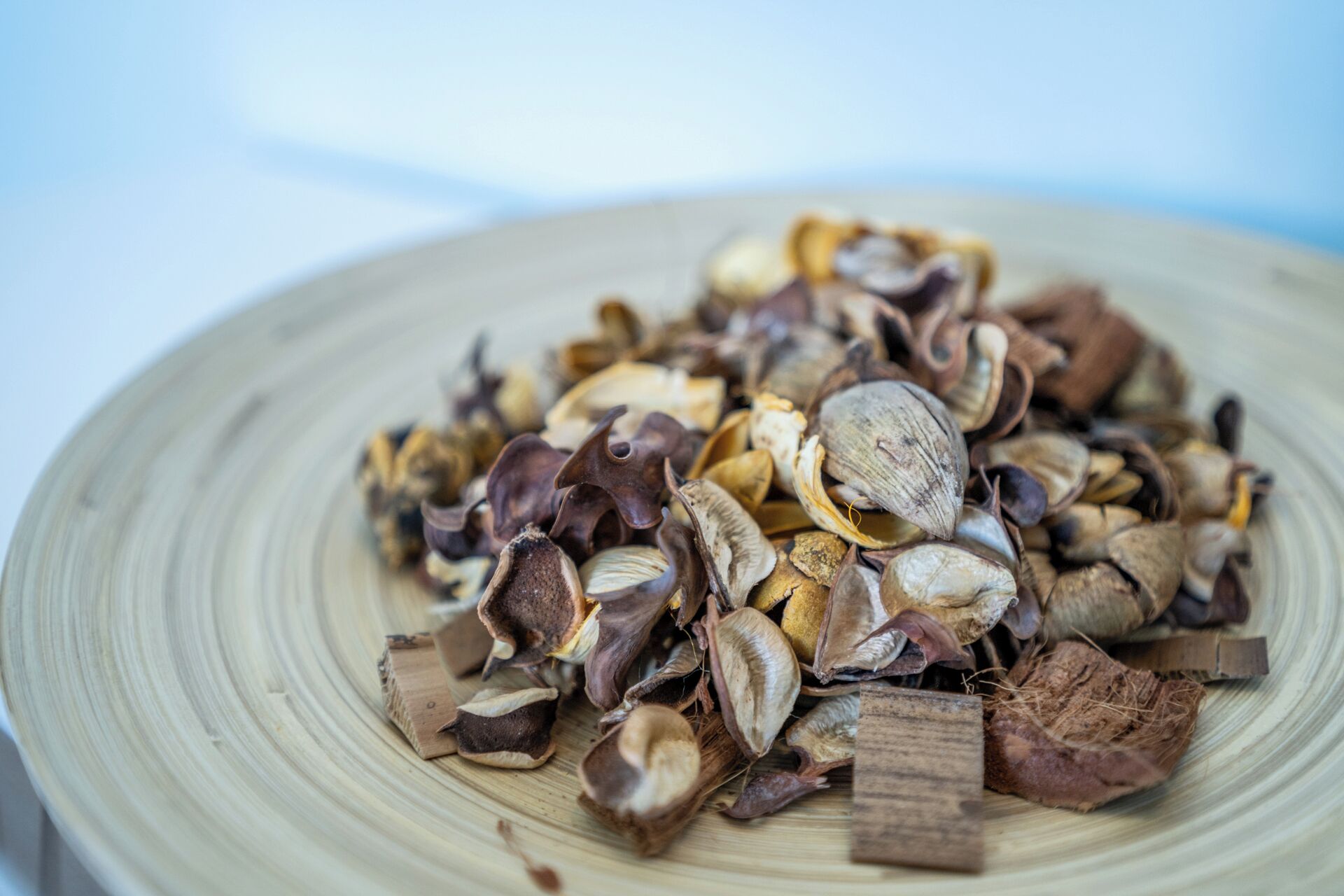 A pile of dried seeds on a wooden plate.