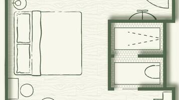 A hotel room layout with a bed, a desk, a bathroom, and a small seating area.