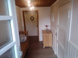 Stylish hallway with a door, cabinet, and radiator.