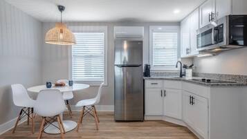 Fridge, microwave, coffee/tea maker, cookware/dishes/utensils