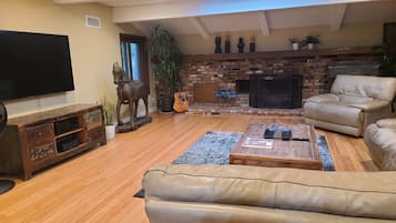 Smart TV, fireplace, books, computer monitors