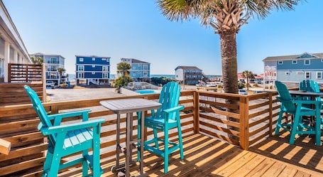 Outdoor dining. Beach House OKI - Queen Suite in hotel on Oak Island, North Carolina