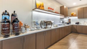 A modern kitchen with a coffee station, stainless steel appliances, and wooden cabinets. - Comfort Suites Fort Myers East I-75 (Fort Myers)