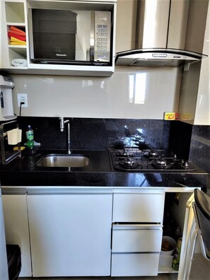 Enjoy cooking in this well-equipped kitchen with a gas stove, microwave, and sink.