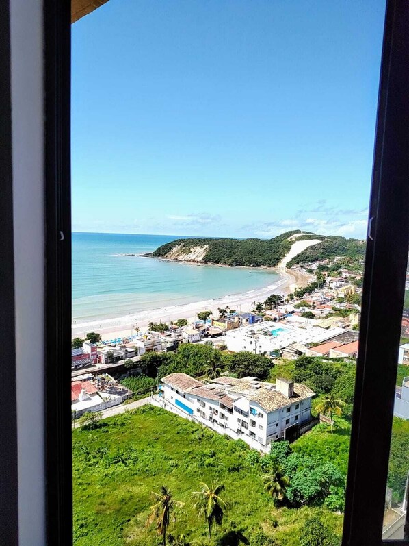 Enjoy breathtaking views of the coastal town from this elevated vantage point, with the beach and sea stretching out to the horizon.