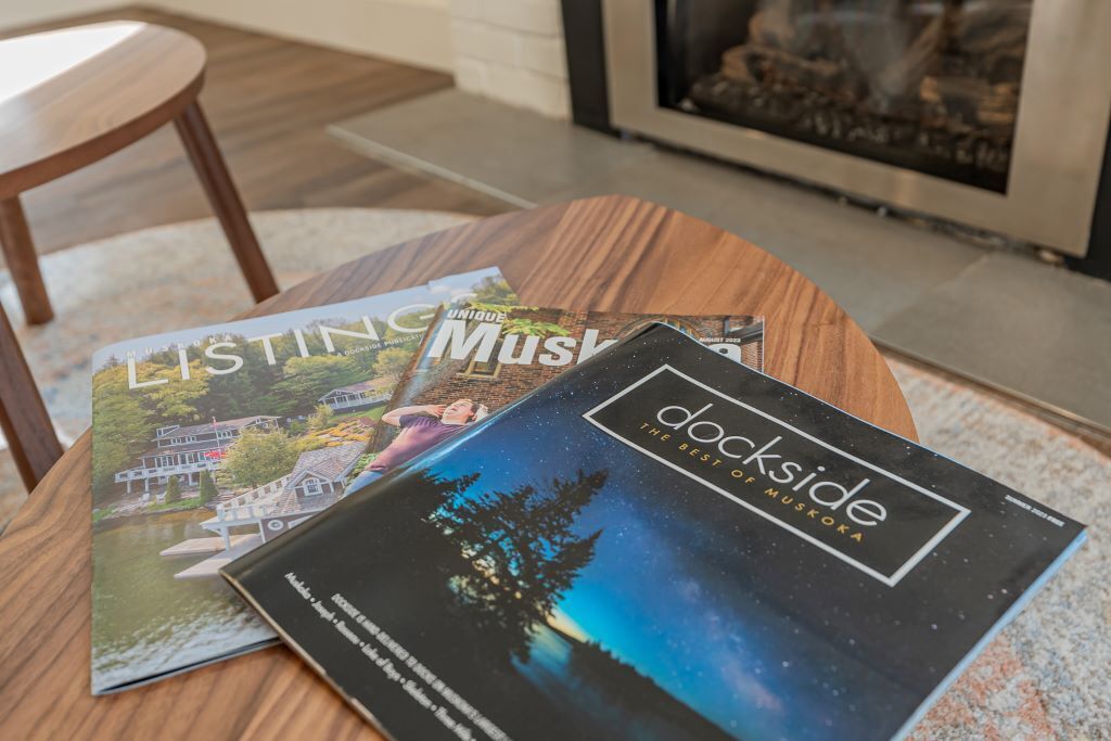 A magazine titled 'Unique Muskogee' and 'Dockside' on a wooden table.