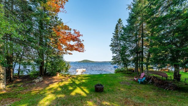 A lakeside property with a dock, a grassy area, and a picnic table. - Pet Friendly Fall Getaway  Waterfront (Huntsville)