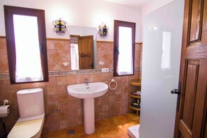Ein Badezimmer mit Toilette, Waschbecken und Spiegel.