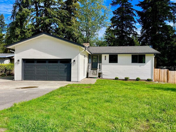 A single-story house with a garage and a small attached shed.
