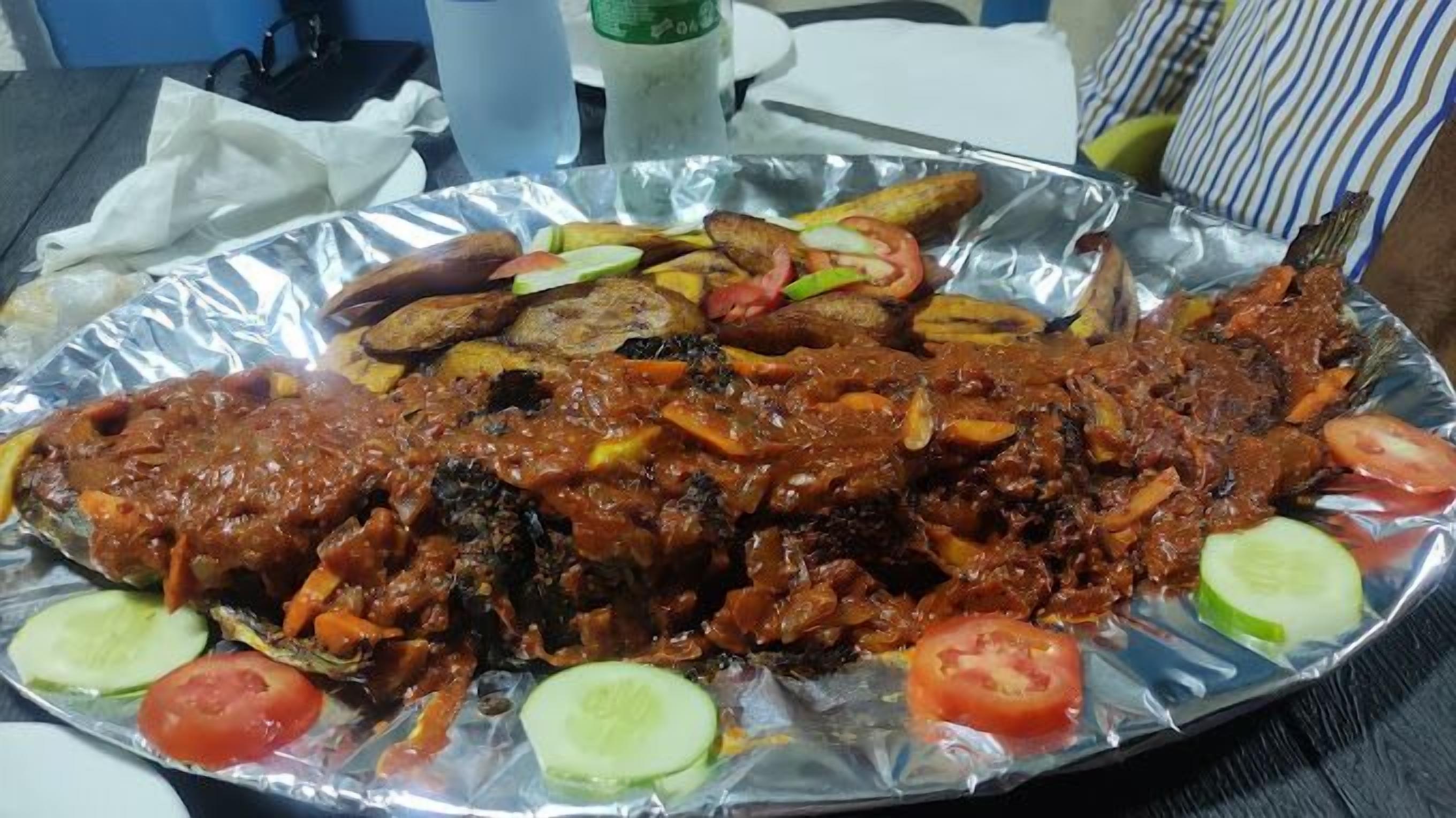 A meal with meat, vegetables, and bread on a table.
