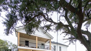 A two-story house with a covered porch and a swing set in the yard. - Brand New Home Family-friendly Nags Head, NC OBX 4 BR 3 BA (Nags Head)
