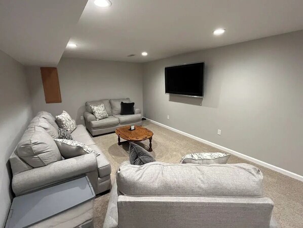 A living room with a sectional sofa, a smaller sofa, and a coffee table.