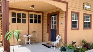A house with a porch, two doors, and a small garden.
