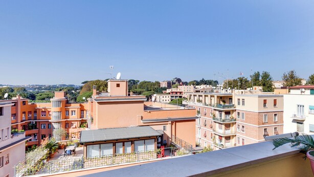 A residential area with multi-story buildings, balconies, and a clear sky. - Strategic location and cozy atmosphere for a perfect Roman vacation. (Roma)