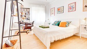 A bedroom with a bed, a desk, a chair, a bookshelf, and a ladder. - Strategic location and cozy atmosphere for a perfect Roman vacation. (Roma)
