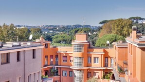 A multi-story building with balconies, satellite dishes, and a clear view of the surrounding cityscape. - Strategic location and cozy atmosphere for a perfect Roman vacation. (Roma)