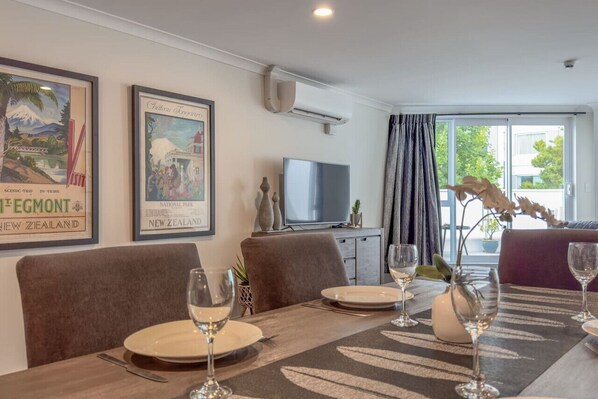 Dining - Warm and plush, inner-city apartment with mod furnishings and tasteful artwork. (Hamilton)