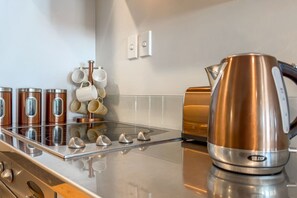 Cookware/dishes/utensils - Warm and plush, inner-city apartment with mod furnishings and tasteful artwork. (Hamilton)
