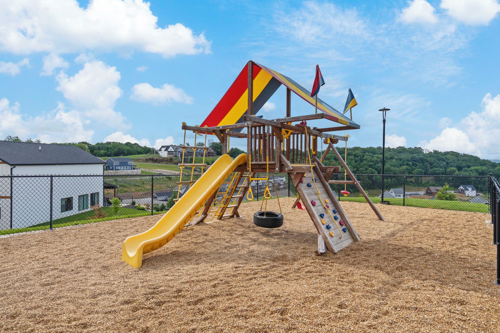 A playground with a slide and climbing structures.