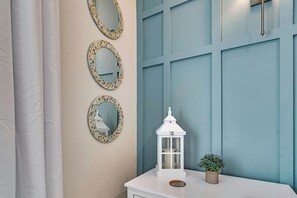 A bathroom with a white vanity, three mosaic mirrors, a white lantern, and a potted plant. - Stunning Table Rock Lake Views with Free Tickets, Indoor & Outdoor Community Pools, Minutes to SDC (Branson)