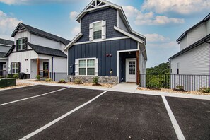 A modern building with a dark facade, white trim, and a stone accent wall. - Stunning Table Rock Lake Views with Free Tickets, Indoor & Outdoor Community Pools, Minutes to SDC (Branson)