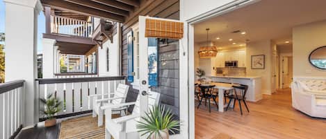 A modern home with a balcony, a dining area, and a kitchen.