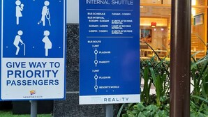 A city shuttle sign with bus schedules and a priority passenger sign. - 101 Newport Blvd: SkyStag Aerie - A cozy studio near NAIA Terminal 3 Airport (Pasay)