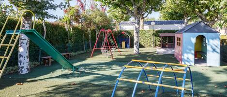 A playground with swings, a slide, and climbing structures.