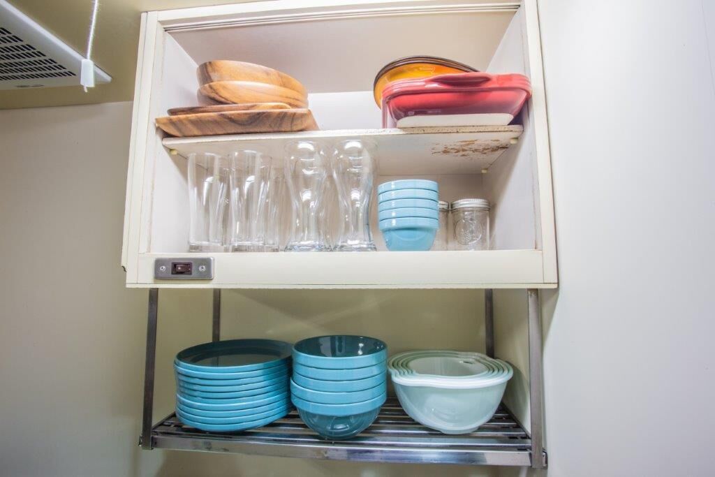 A kitchen with a built-in refrigerator, a microwave, and a sink.
