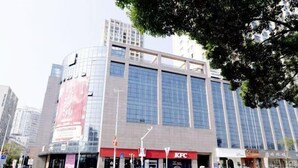 A modern building with a KFC restaurant at the ground level. - Youth Holiday Hotel (Fuding)