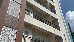 A multi-story building with balconies, decorative lattice panels, and a clear sky. - SAGAR NIWAS (Anekal)