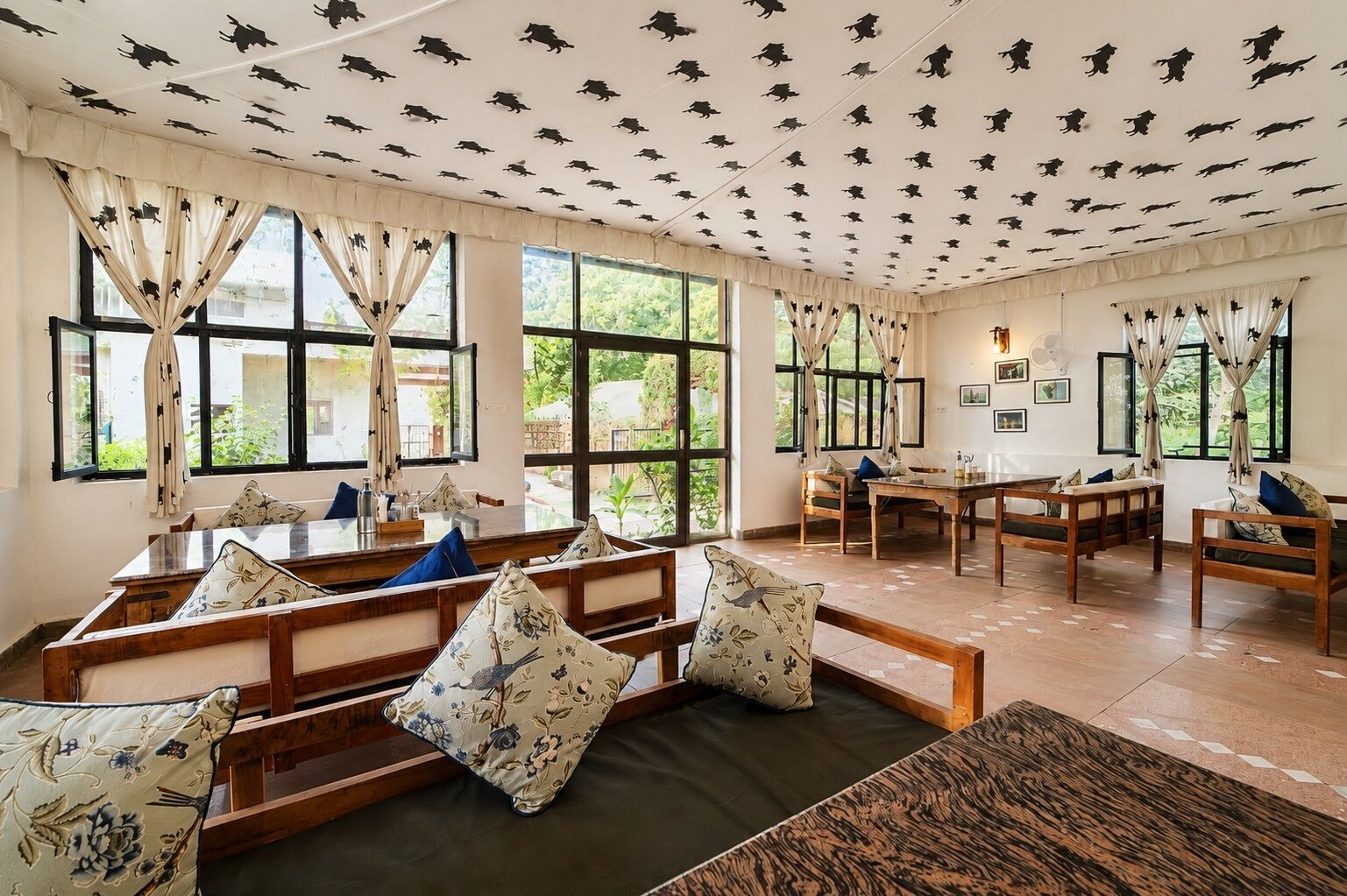 A room with a long wooden bench, a table, and chairs.