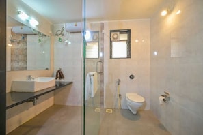 A modern bathroom with a glass-enclosed shower, a standalone toilet, and a vanity with a sink. - Tokyo Villa By Staymatic Villa's (Mawal)