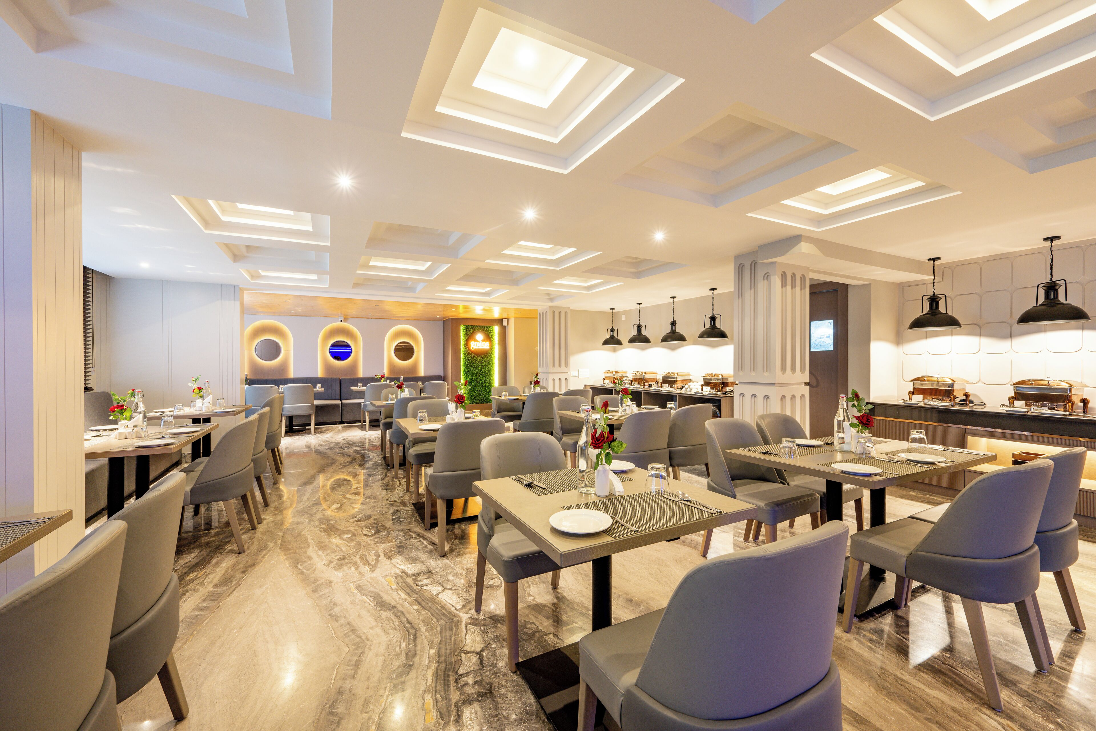 A modern dining area with rectangular ceiling lights, marble flooring, and neatly arranged tables and chairs.