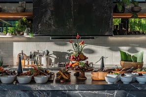 A kitchen counter with various food items and utensils. - Coco Bay (Canggu)