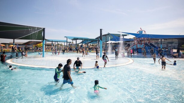 A water park with multiple pools, slides, and a covered area. - Tropical Treasure | Outdoor Kitchen & Shower (Wanguri)