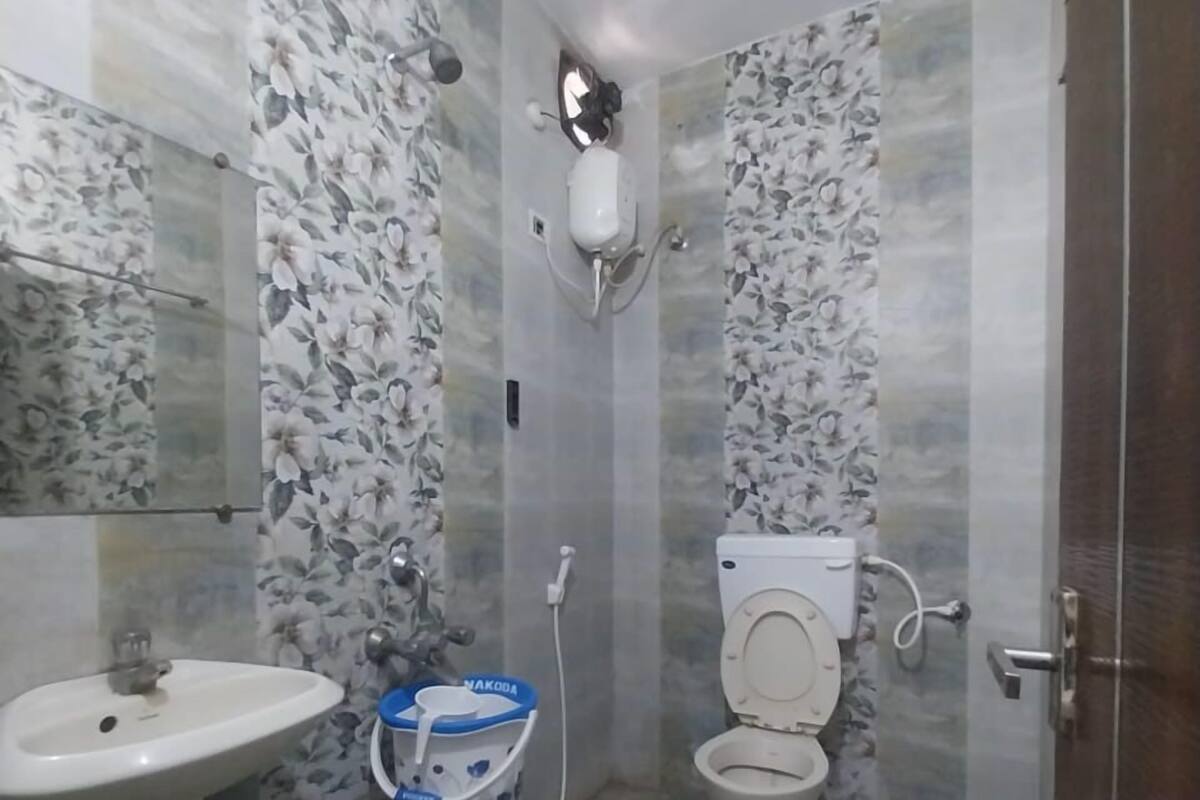 A bathroom with a toilet, sink, and a water dispenser.