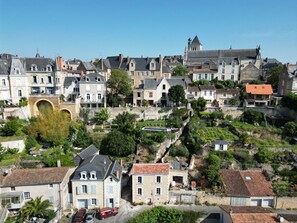 A historic town with stone buildings, a prominent church tower, and a stone bridge. - Au Petit Thouars (Thouars)