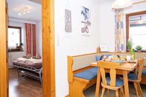 A cozy room with a wooden bench, a small table, and a bed.