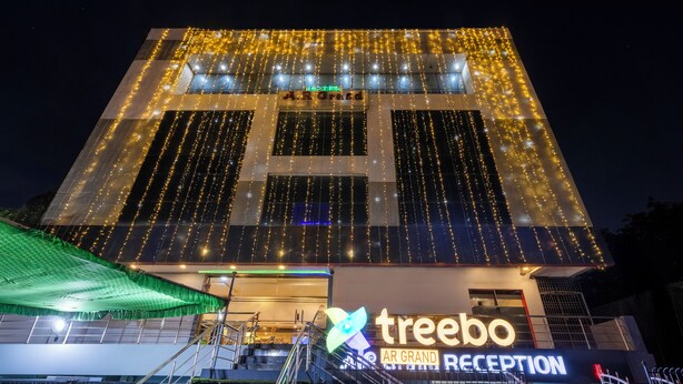 A hotel with a reception area, a staircase, and a sign that reads "treebo AR GRAND RECEPTION". - Treebo AR Grand, Gajuwaka (Visakhapatnam)
