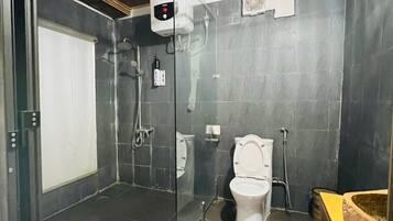 A bathroom with a shower, toilet, and a sink.
