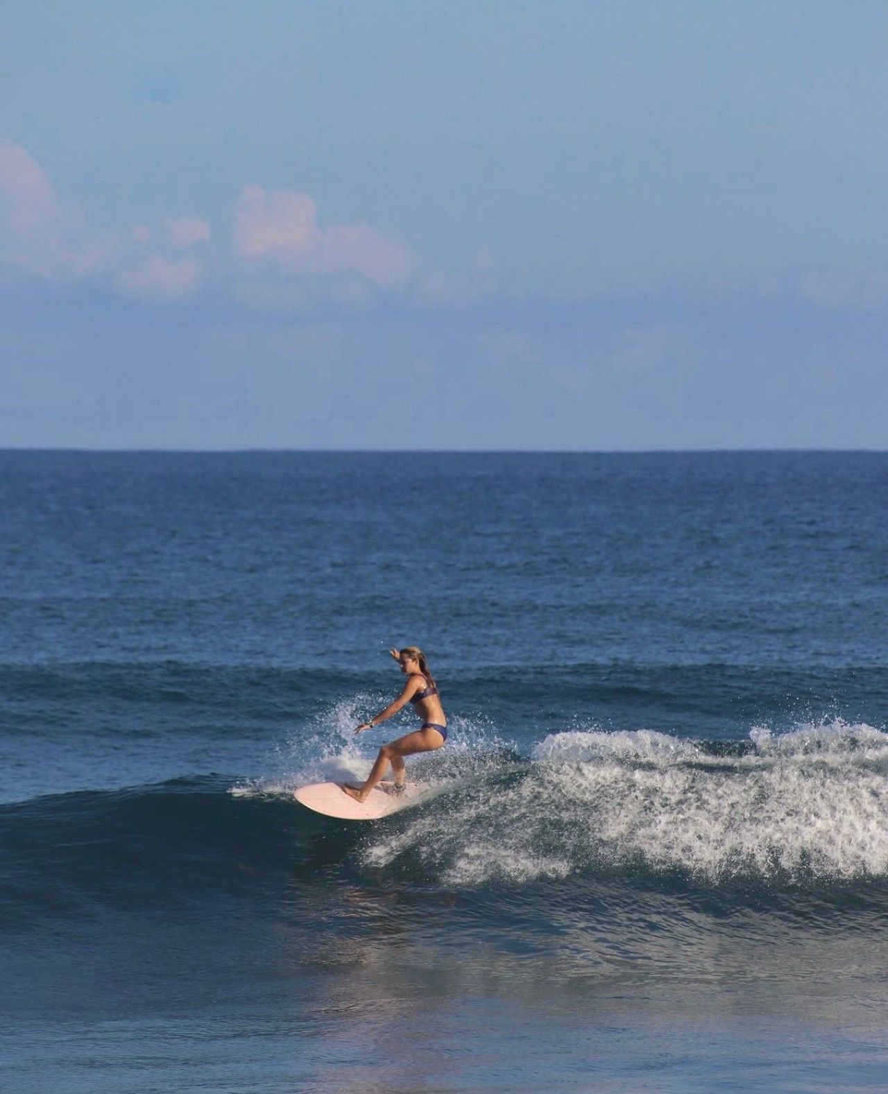 A person surfing on a wave in the ocean.