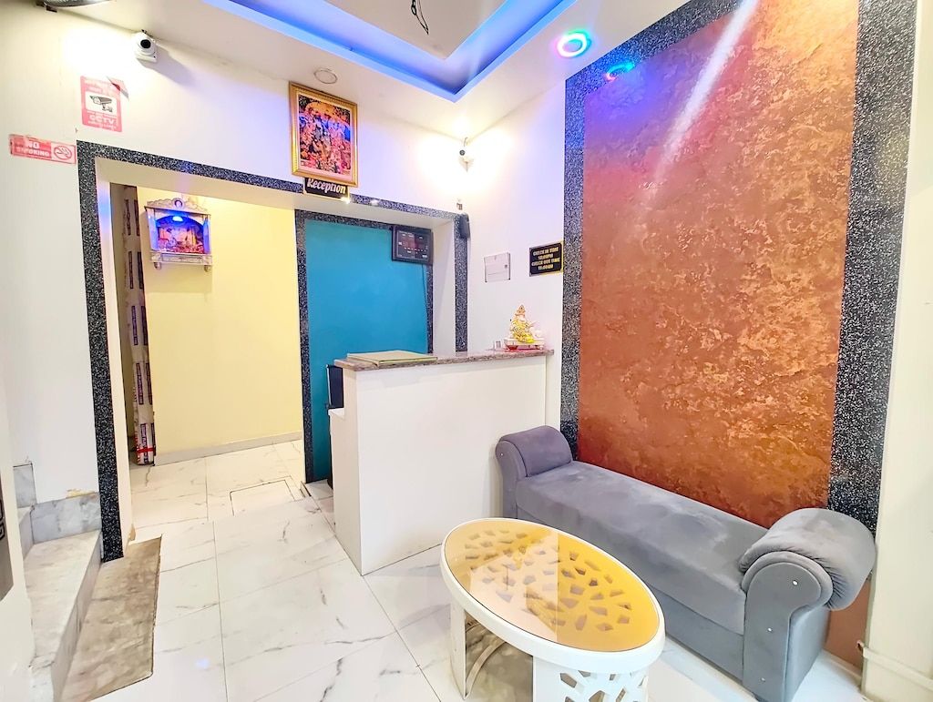 A reception area with a reception desk, a sofa, and a small round table.