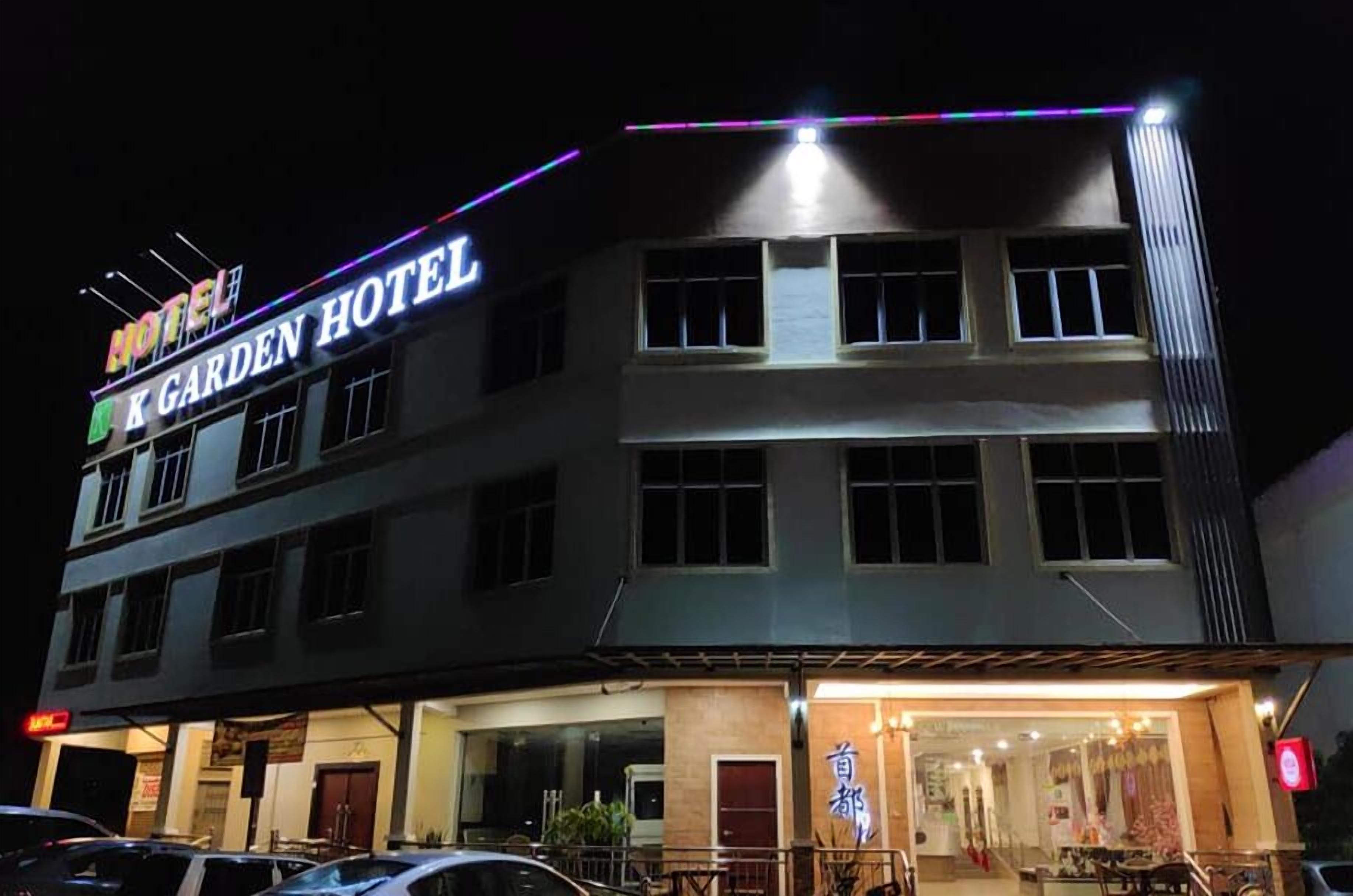 A two-story building with a sign reading "K Garden Hotel".