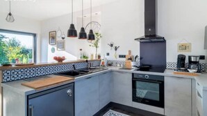 A modern kitchen with a built-in oven, a stove, and a coffee maker. - Cosy, country-style 3* gîte in the heart of Picardy's heritage, sleeps 5 (Mesbrecourt-Richecourt)