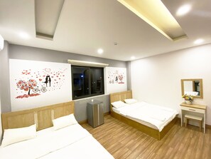 A modern bedroom with a wooden headboard bed, a small bedside table, a mirror, and a window with a view of the outside. - Jolilian Hotel & Apartment (Ho Chi Minh City)